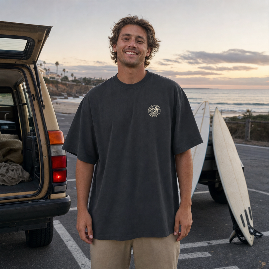Faded black Circular Wave Crest embroidered oversized tee at the coast