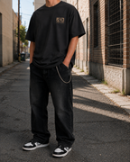 Wave Badge Heavyweight Tee in faded black, city alley