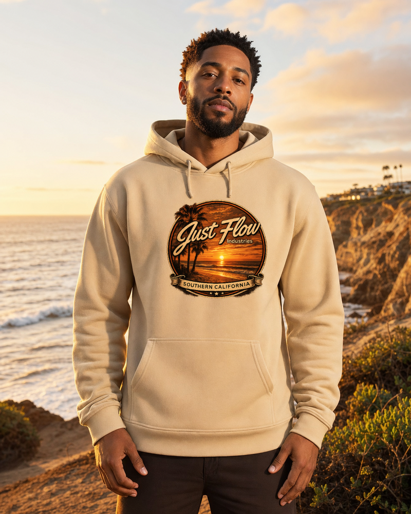 Golden Hour Feature hoodie in Sand, sunset badge across the chest, Southern California coast at golden hour