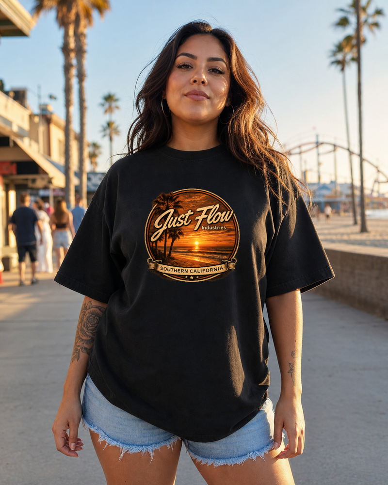 Golden Hour Feature heavyweight tee in Black, sunset badge across the chest, Southern California boardwalk at golden hour