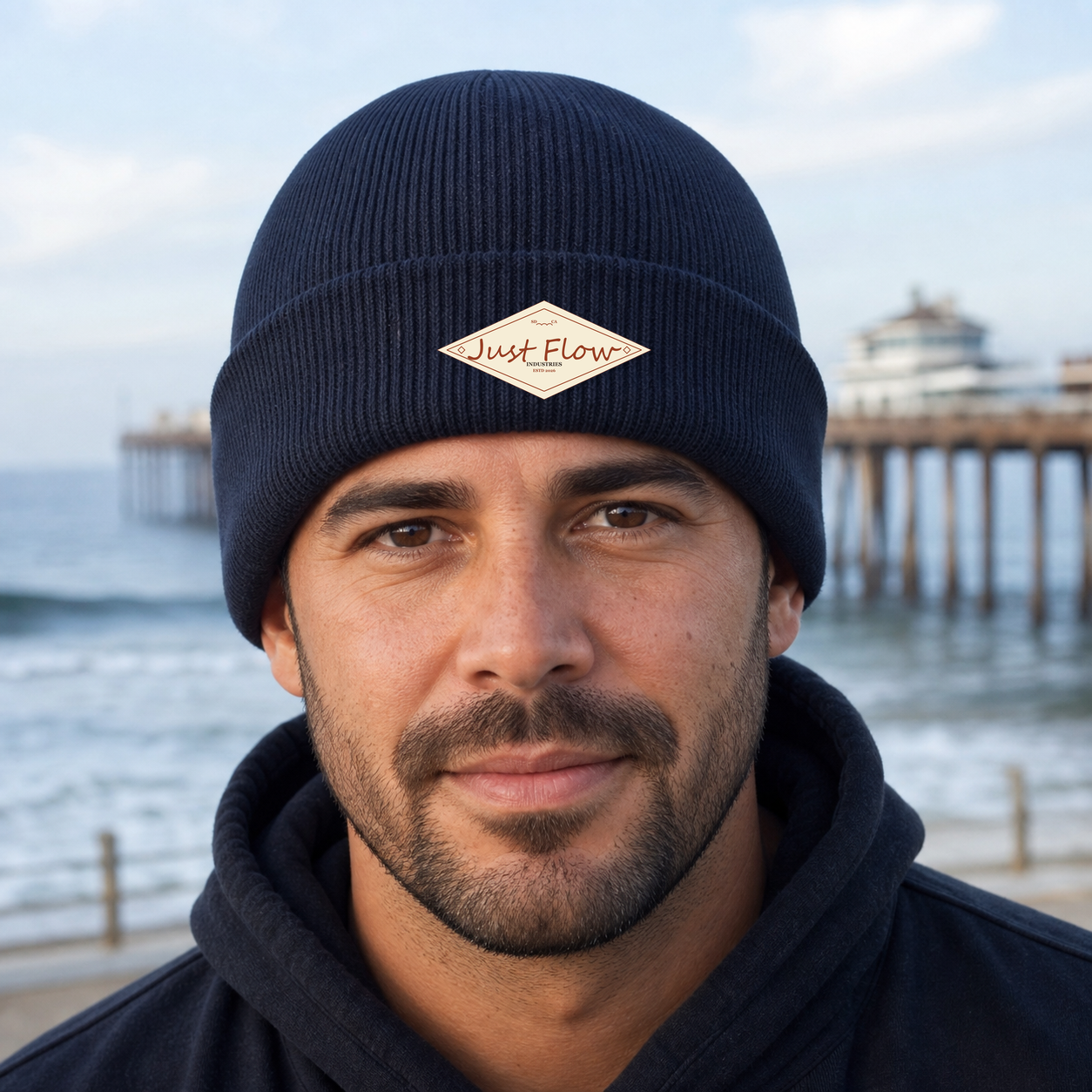 Embroidered Diamond Badge Beanie lifestyle hero, pier at golden hour