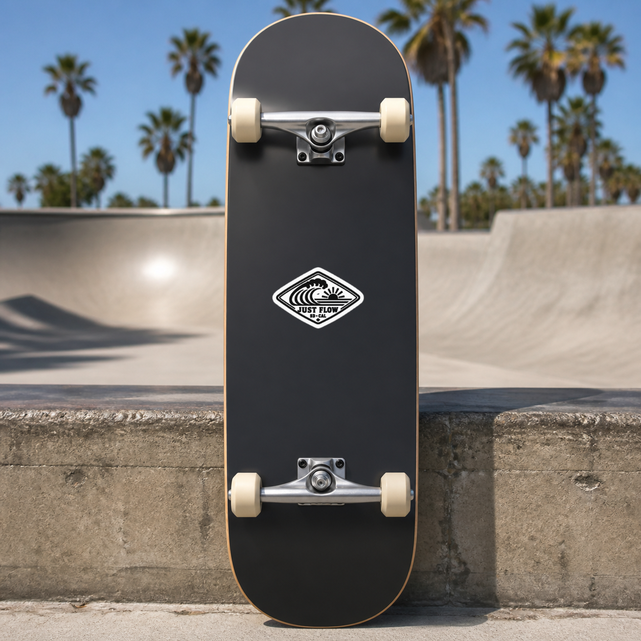 Horizontal Wave Diamond sticker, black mark on white, on a charcoal skateboard underside