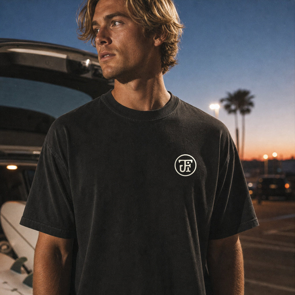 After Dark tee, front monogram in a surf-lot at night