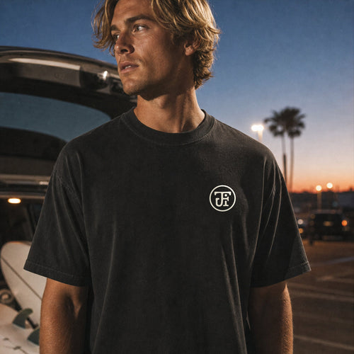 After Dark tee, front monogram in a surf-lot at night
