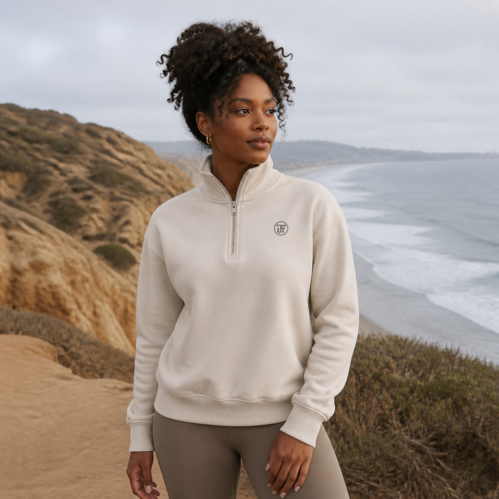 JFI Monogram Half-Zip Pullover in dust, coastal bluff above the beach