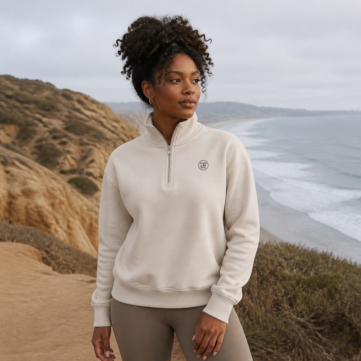 JFI Monogram Half-Zip Pullover in dust, coastal bluff above the beach