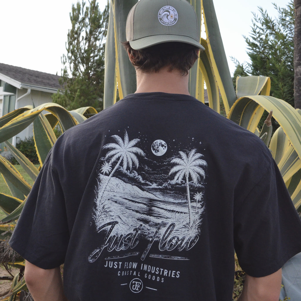 After Dark Heavyweight Tee in washed black, back print worn in a San Diego agave garden