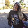 Slow Days Graphic Crew Sweatshirt in brown, worn on a palm lined San Diego street at golden hour