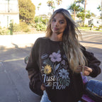 Slow Days Graphic Crew Sweatshirt in brown, worn on a palm lined San Diego street at golden hour