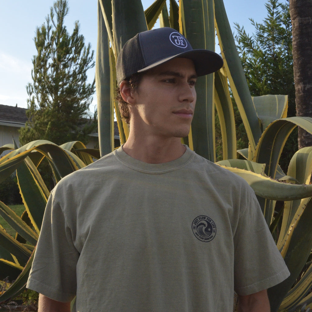 Circular Wave Crest Heavyweight Tee in sage, front logo worn in a San Diego agave garden