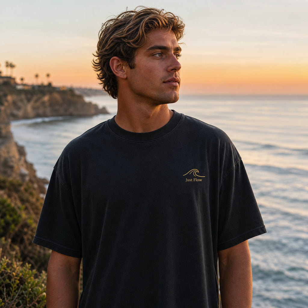 Ride the Current tee, front gold wave at a cliff surf-check