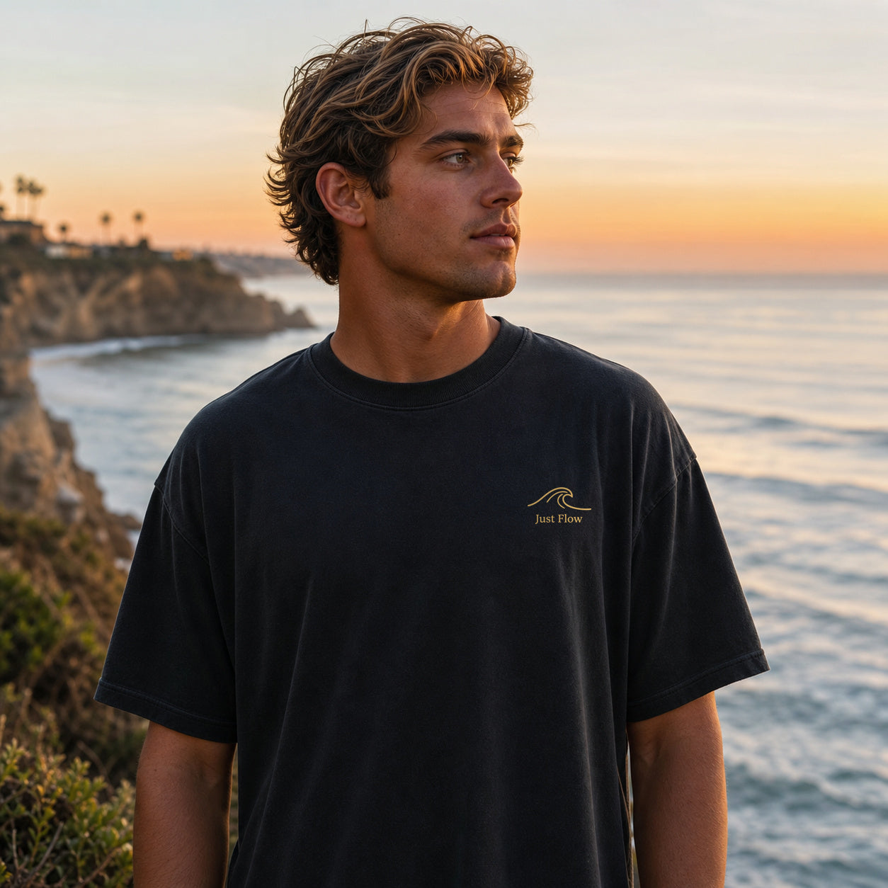 Ride the Current tee, front gold wave at a cliff surf-check