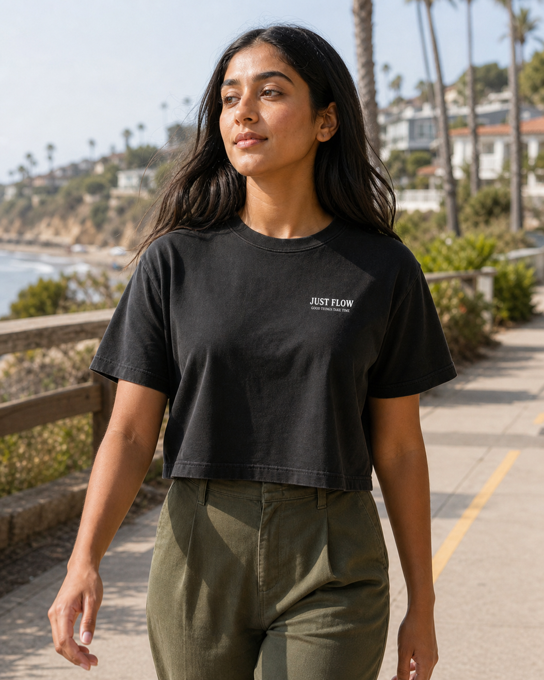 Woman wearing the Minimal Wordmark Cropped Tee on a Southern California coastal path