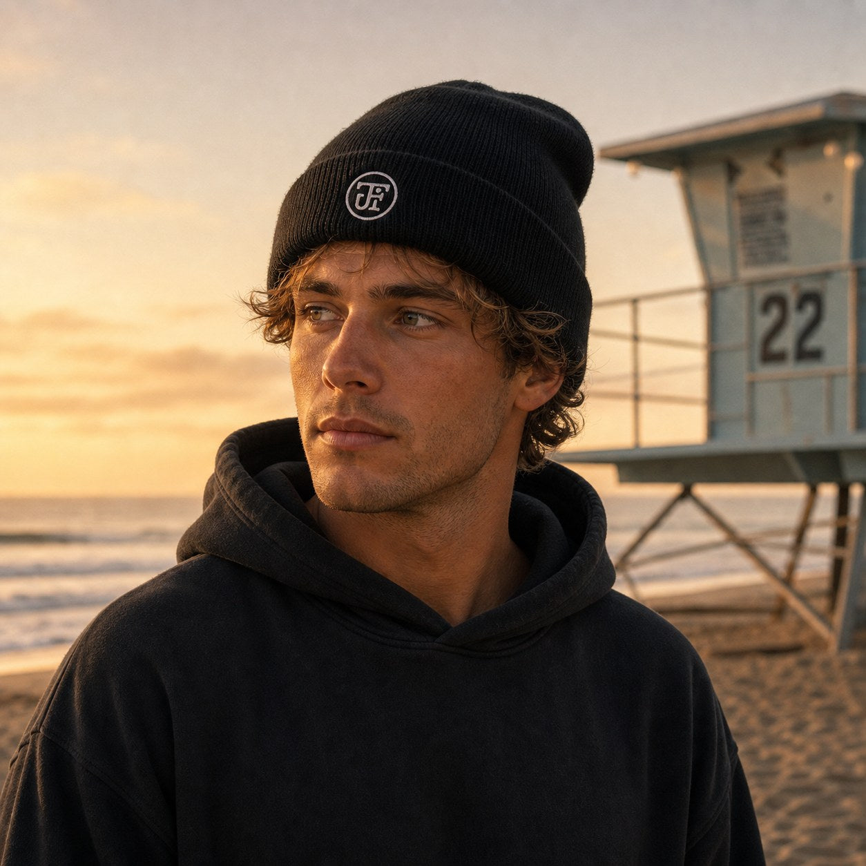 Embroidered JF monogram beanie at the lifeguard tower, dawn