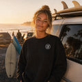 Black monogram fleece crew at the morning surf lineup
