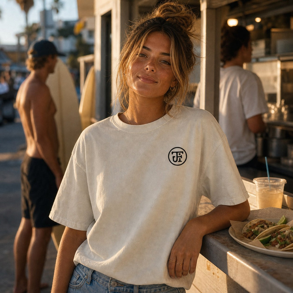 Washed light monogram tee at a boardwalk taco stand