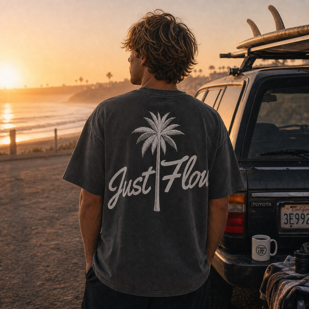 Washed dark palm script tee at a dawn surf-check parking lot