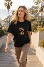 Woman wearing the Palm Smoke Heavyweight Tee while walking up coastal stairs