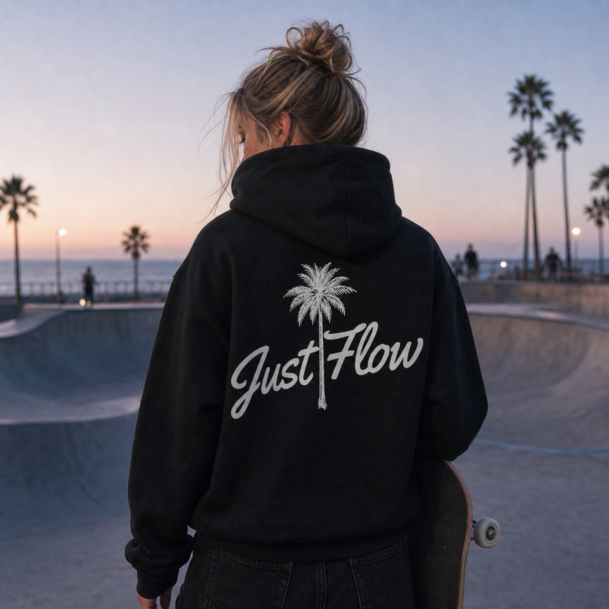 Black palm script hoodie at the skatepark bowl, blue hour