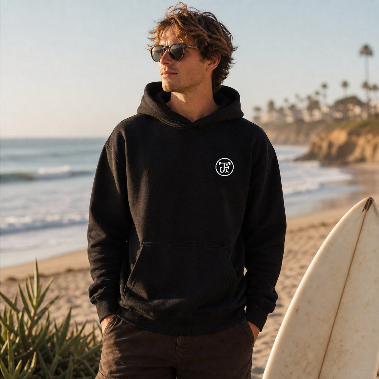 Embroidered Monogram Hoodie on the beach at golden hour
